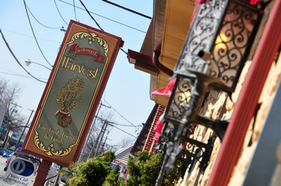 A sign on a pole that says harvest on it