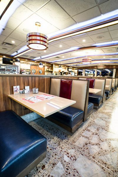A diner with a row of booths and tables