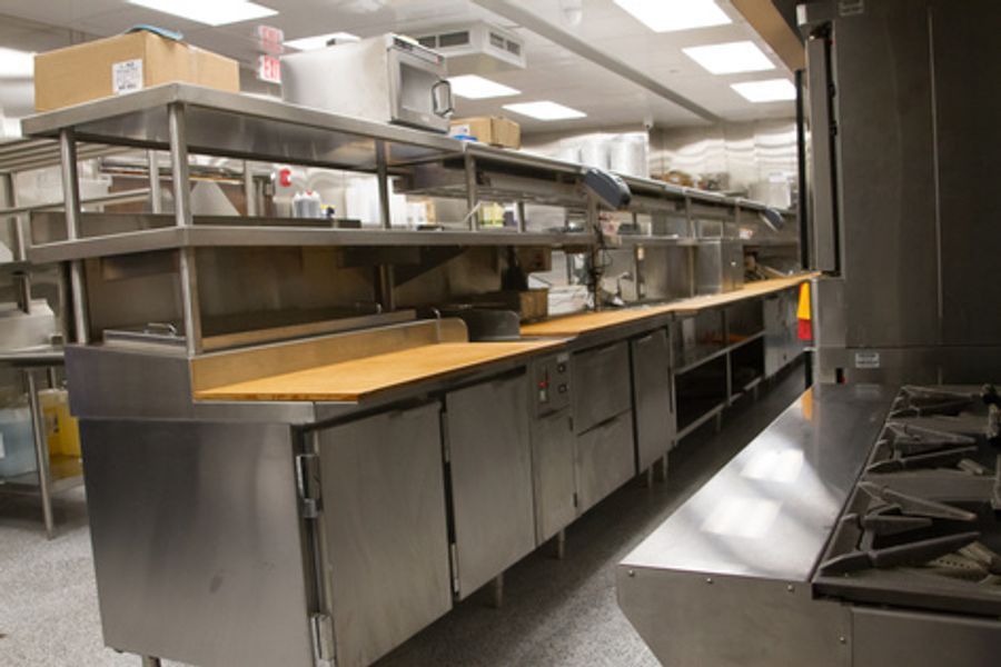 A kitchen with stainless steel appliances and wooden counter tops
