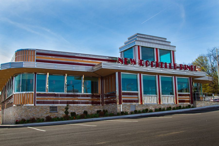 A diner with a lot of windows and the word diner on it