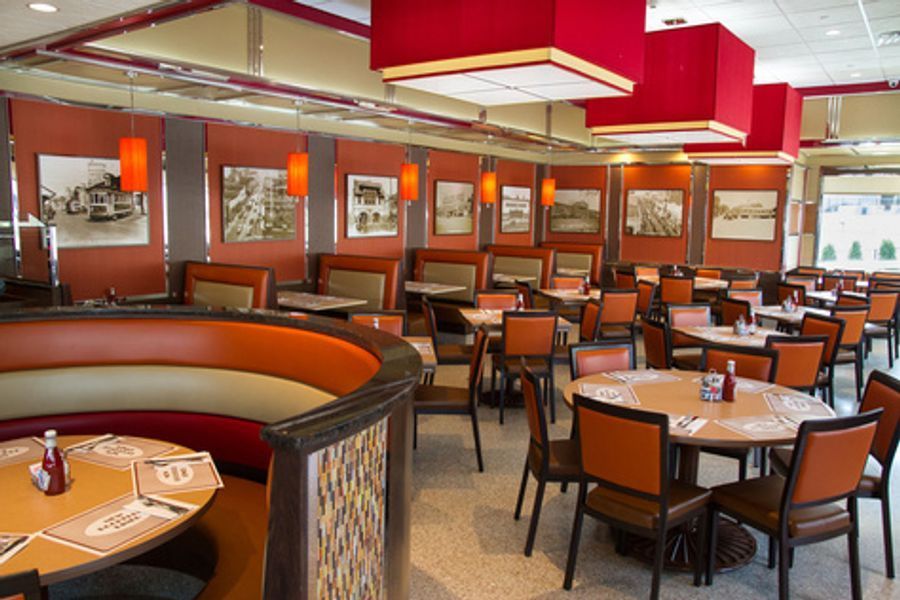 A restaurant with a lot of tables and chairs