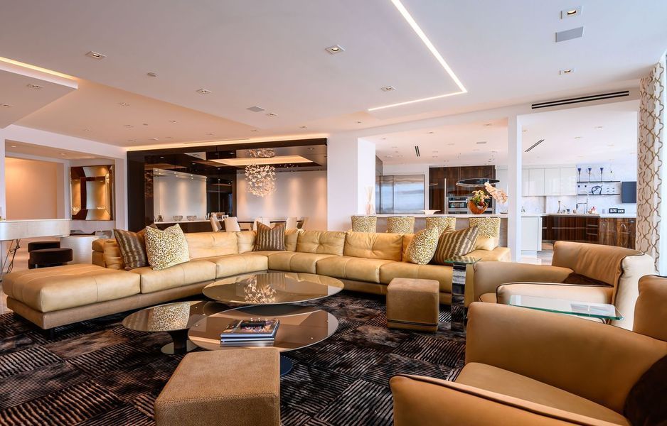 A living room with a large couch and chairs