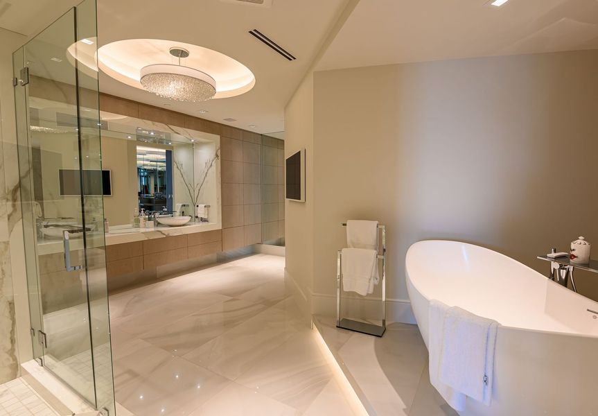 A bathroom with a bathtub and a walk in shower