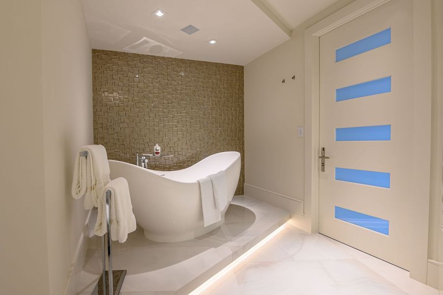 A bathroom with a bathtub and a blue door