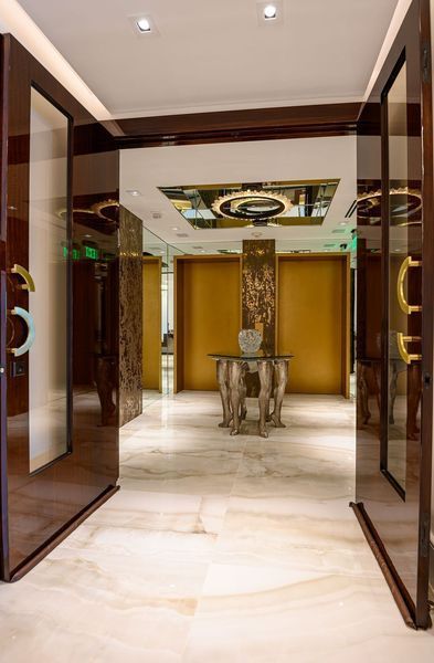 A hallway with sliding glass doors and a table in the middle