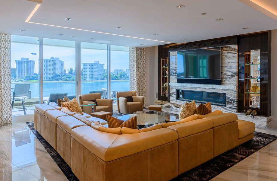 There is a large couch in the middle of the living room