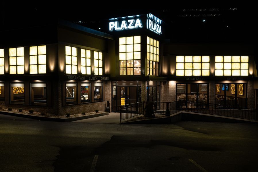 A large building with a lot of windows is lit up at night