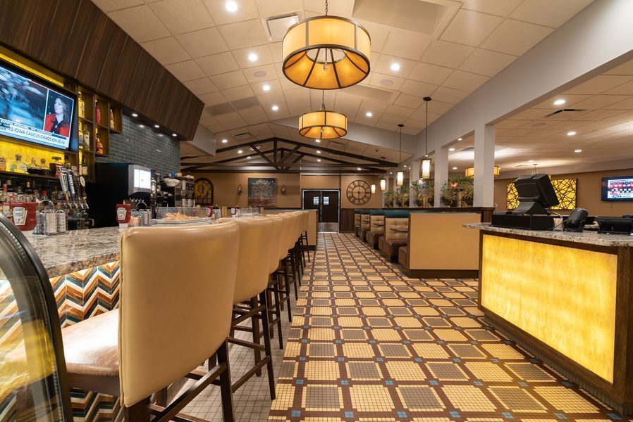 A long row of bar stools in a restaurant