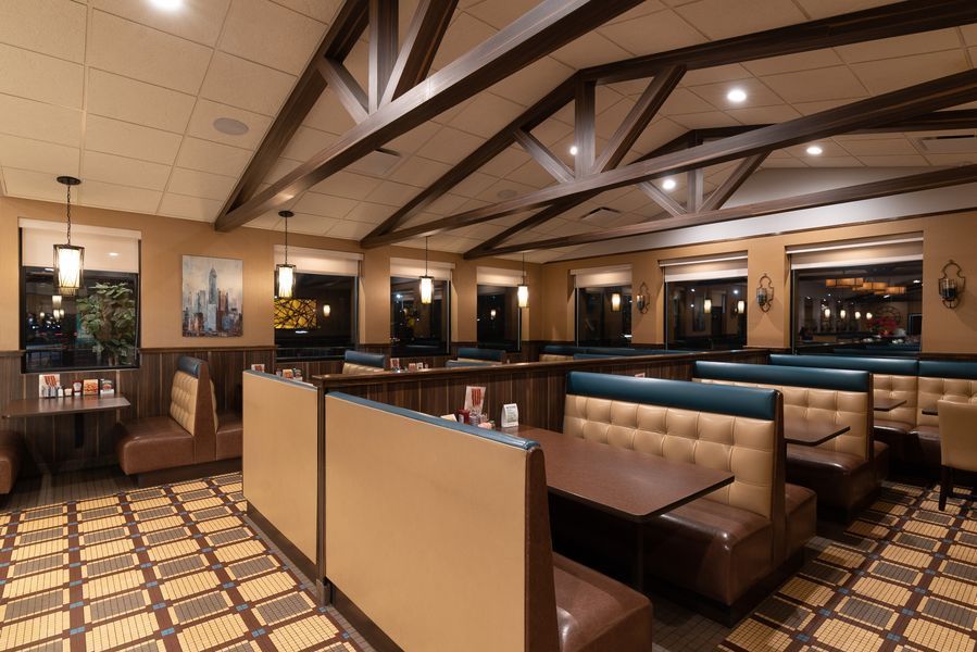 A restaurant with a lot of booths and tables