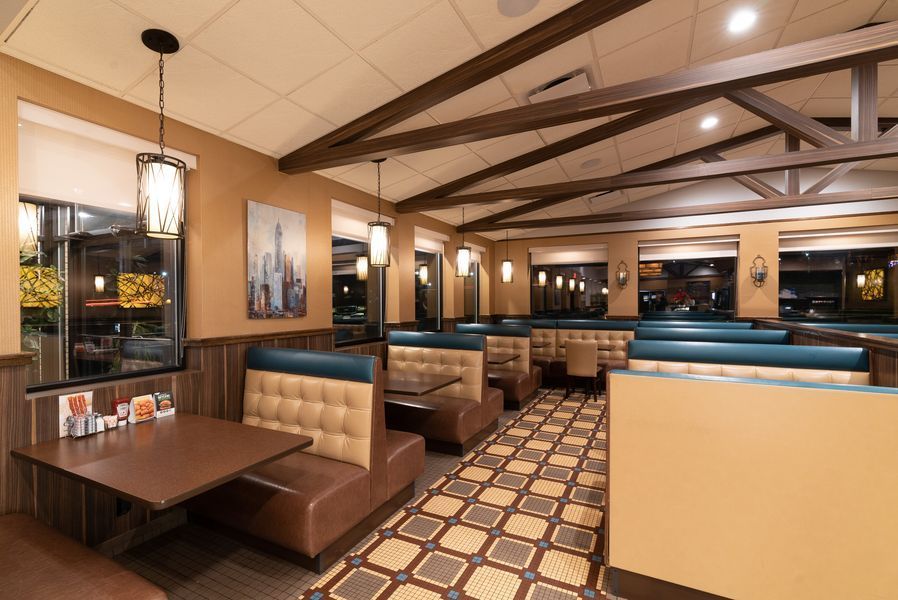 A restaurant with a lot of booths and tables