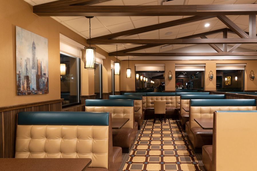A diner with tables and booths and a painting on the wall