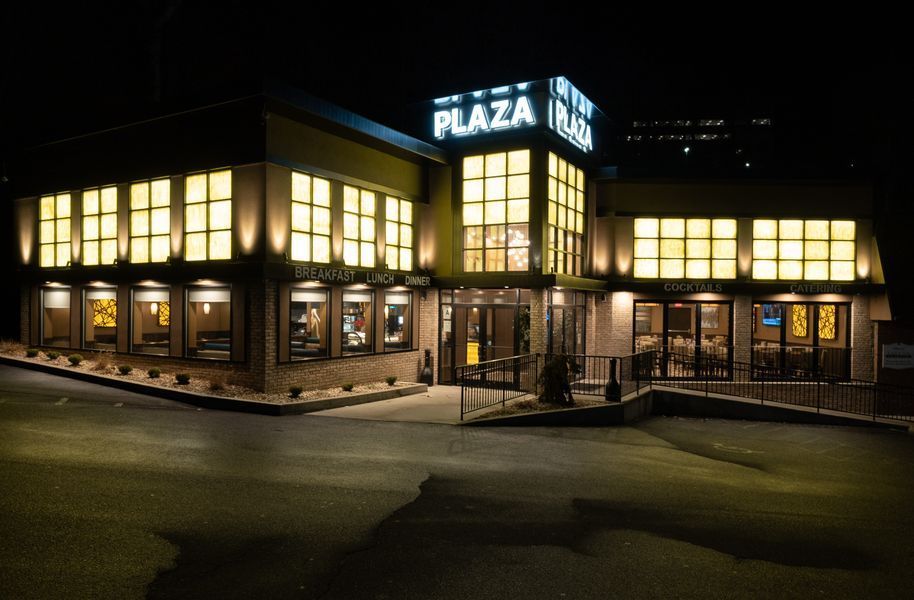 A large building with a lot of windows is lit up at night