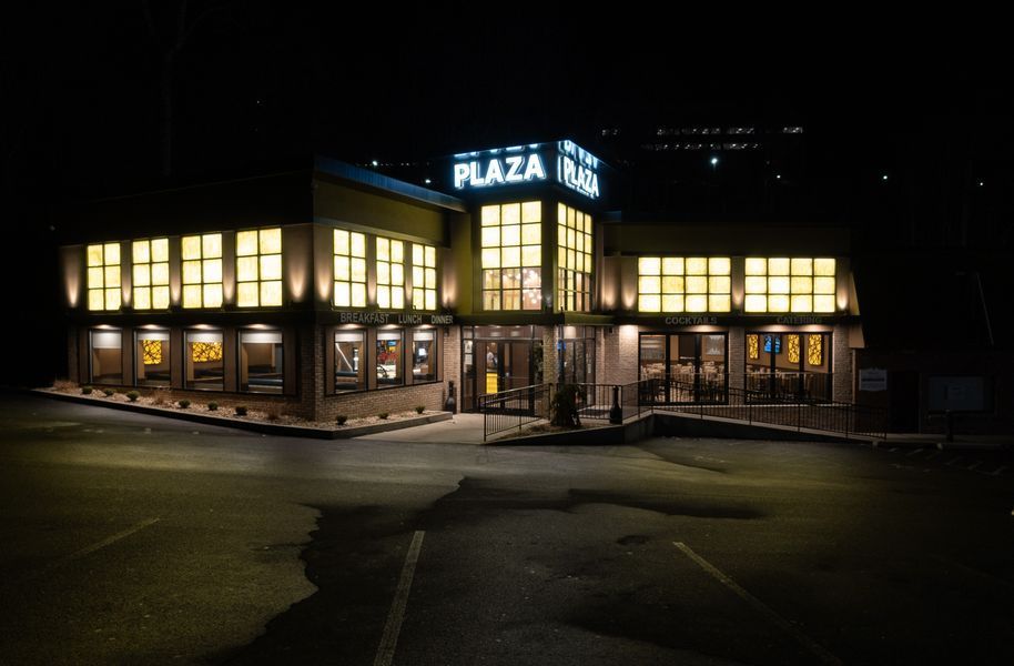 A large building with a lot of windows is lit up at night