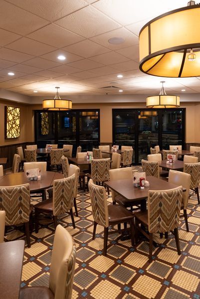 A large dining room with tables and chairs in it