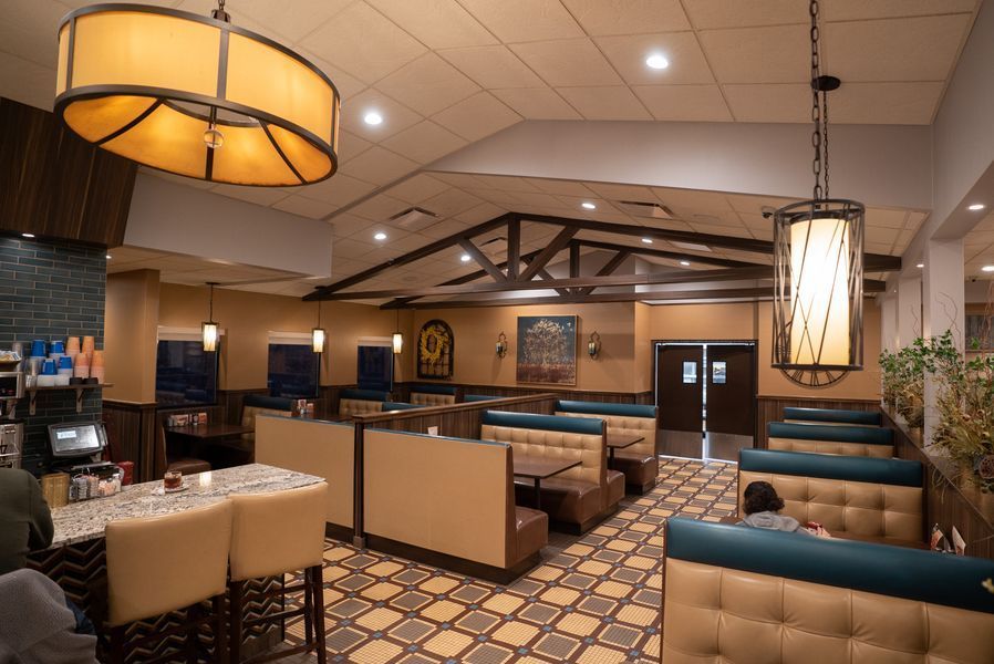 A restaurant with a lot of booths and tables