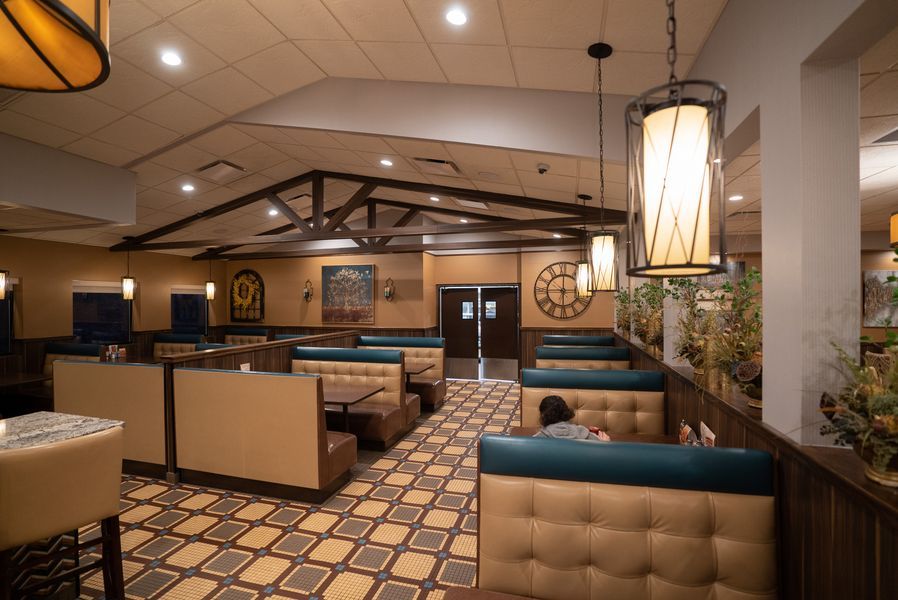 A restaurant with a lot of booths and tables