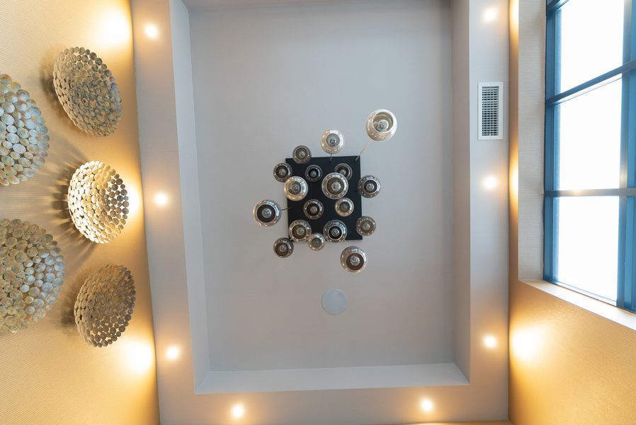 A ceiling with a lot of circles on it and a window