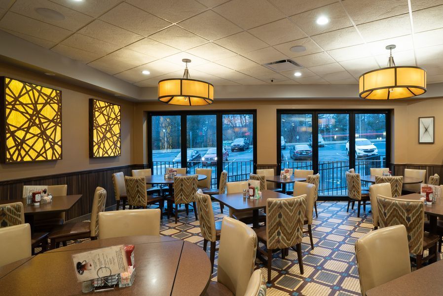 A restaurant with tables and chairs and a lot of windows