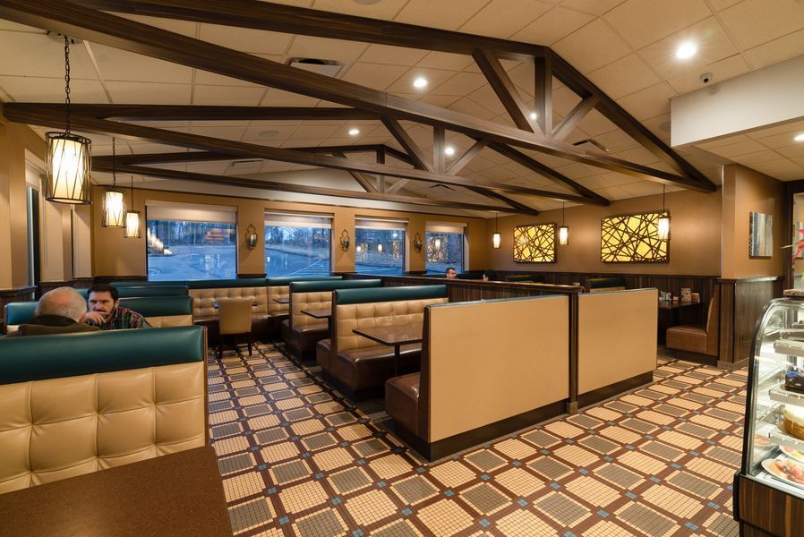 A man is sitting in a booth in a restaurant