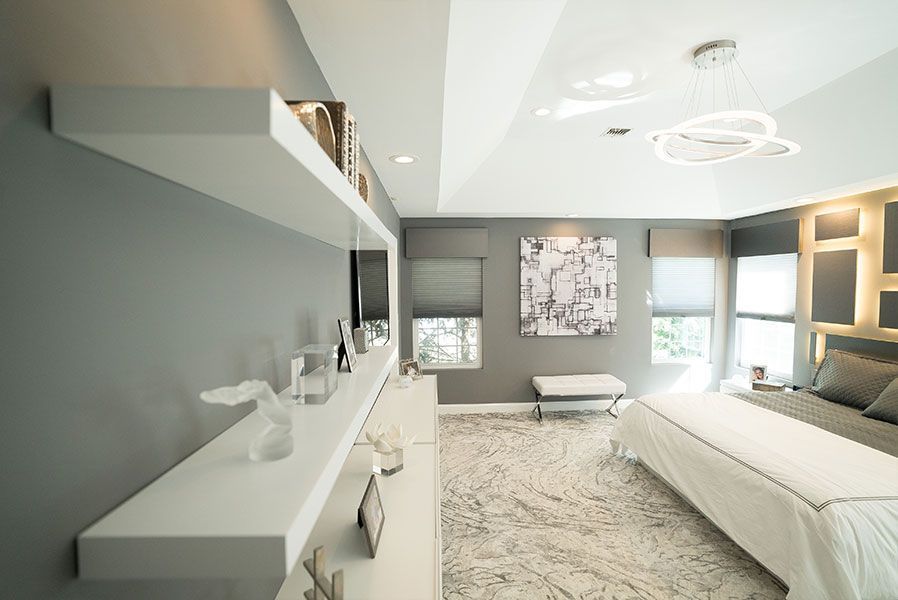 A bedroom with a bed, dresser, shelves and a painting on the wall