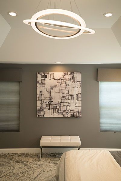 There is a painting on the wall above the bed in the bedroom