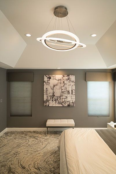 There is a painting on the wall above the bed in the bedroom