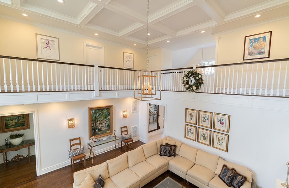 A living room with a large sectional couch and a balcony