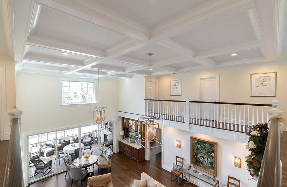 An aerial view of a living room and dining room with a balcony