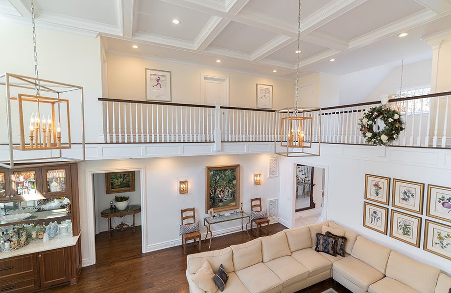 A living room with a large sectional couch and a balcony