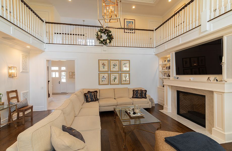 A living room with a large sectional couch and a fireplace