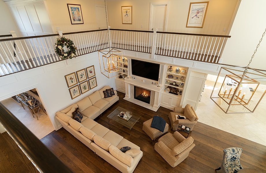 An aerial view of a living room with a large sectional couch and a fireplace