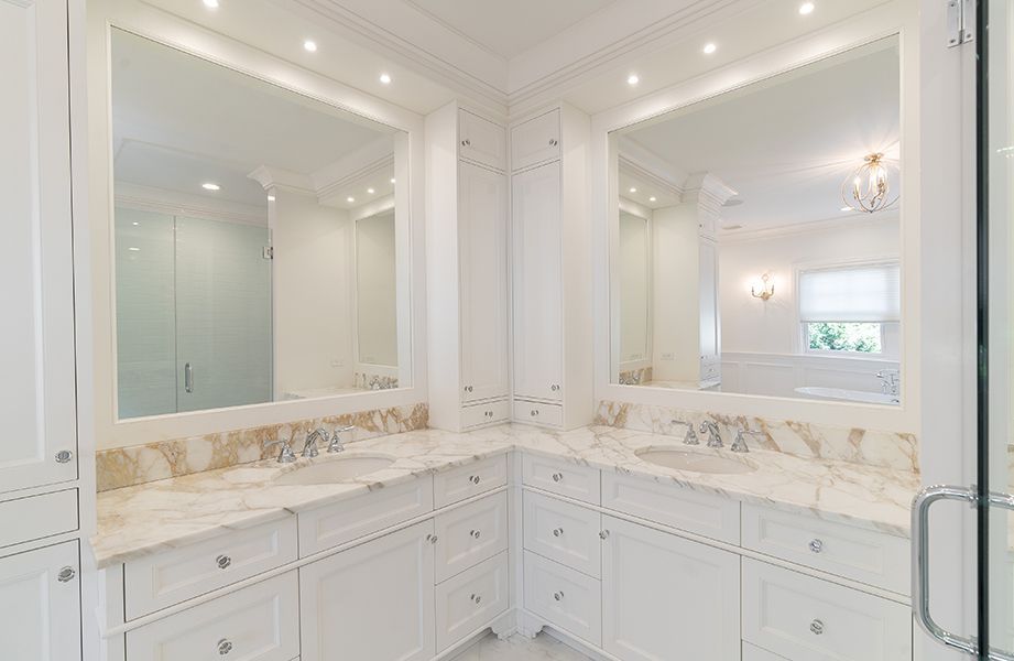 A bathroom with two sinks and two mirrors
