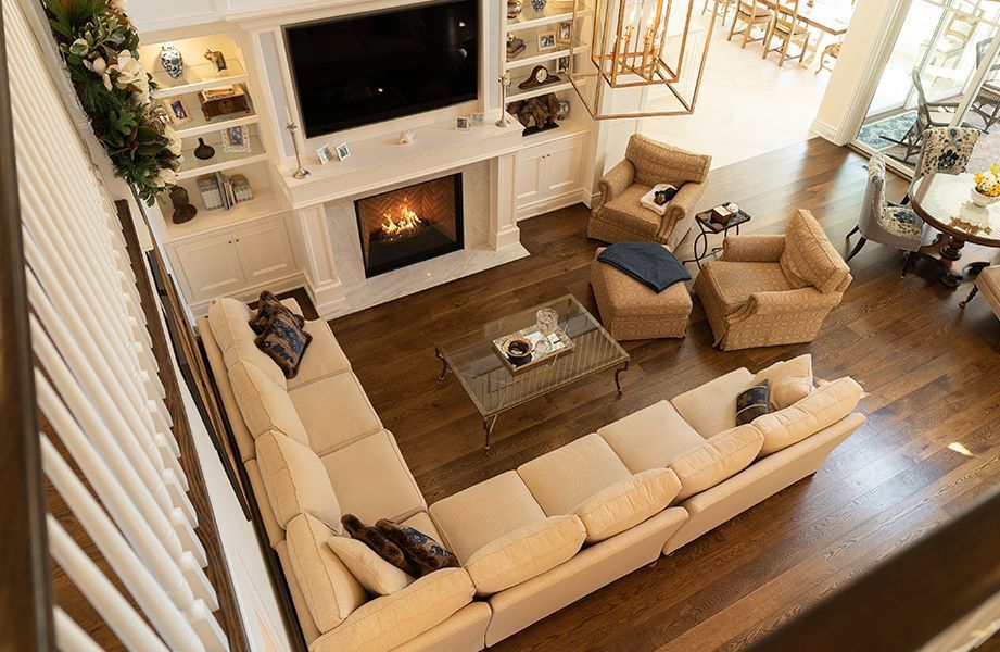 An aerial view of a living room filled with furniture and a fireplace