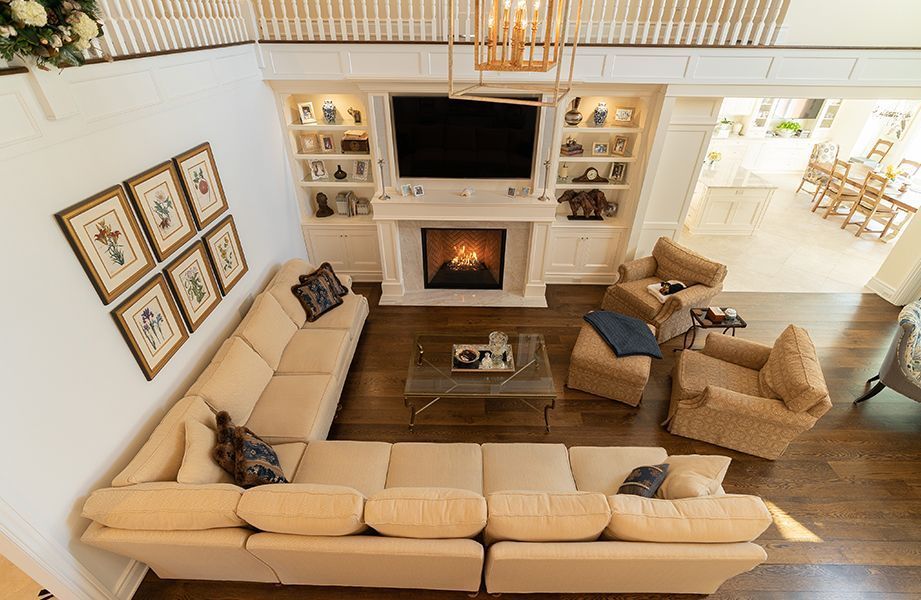 An aerial view of a living room filled with furniture and a fireplace