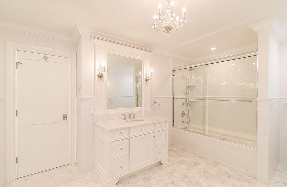 A bathroom with a sink, mirror, tub and shower