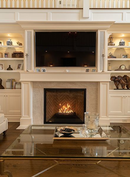 A living room with a fireplace and a flat screen tv