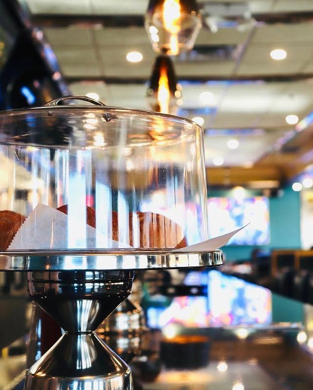 A glass container with a donut inside of it