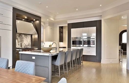 A large kitchen with a dining table and chairs and a large island.