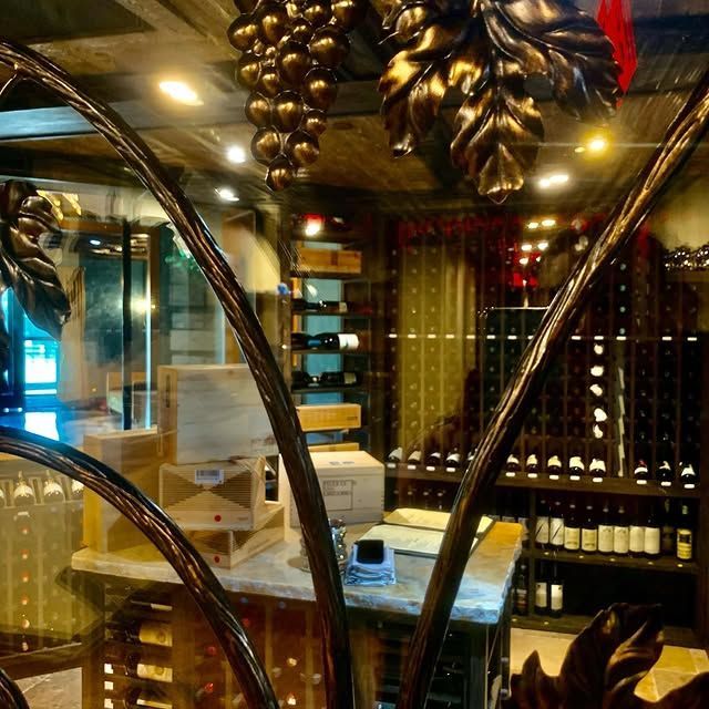 A wine cellar with a bunch of grapes on the ceiling