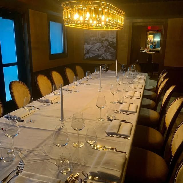 A long table with a lot of wine glasses on it