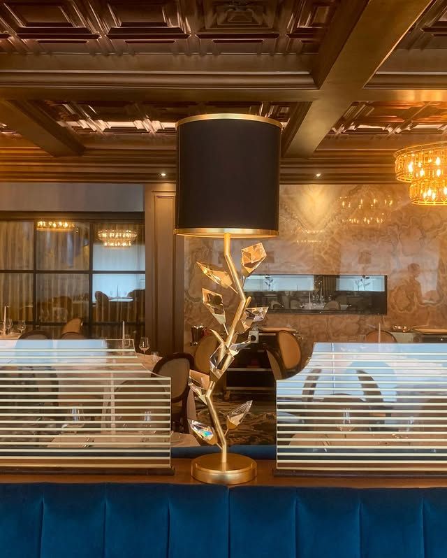 A lamp is sitting on a table in a restaurant.