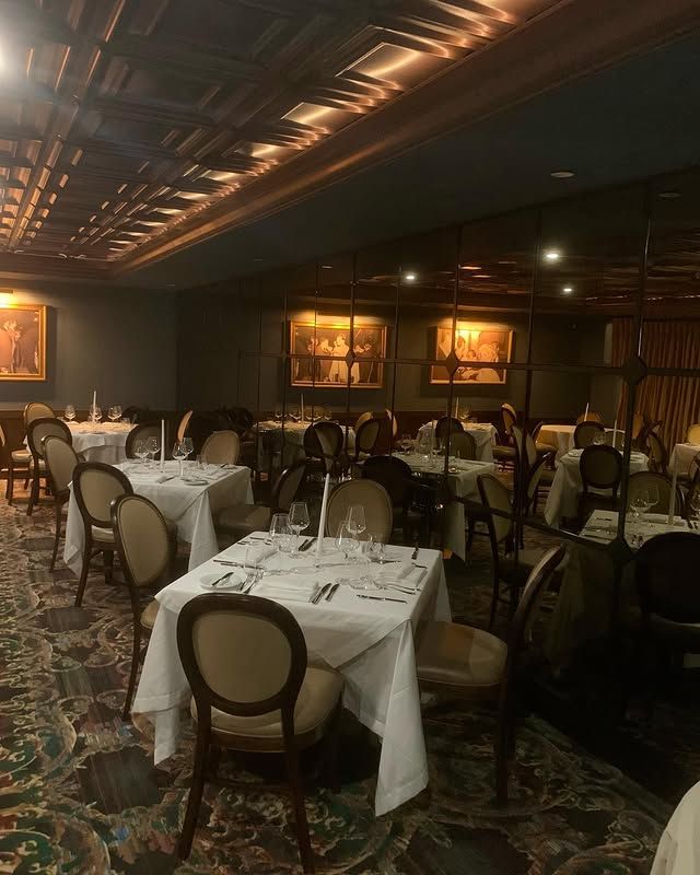 A large dining room with tables and chairs set for dinner