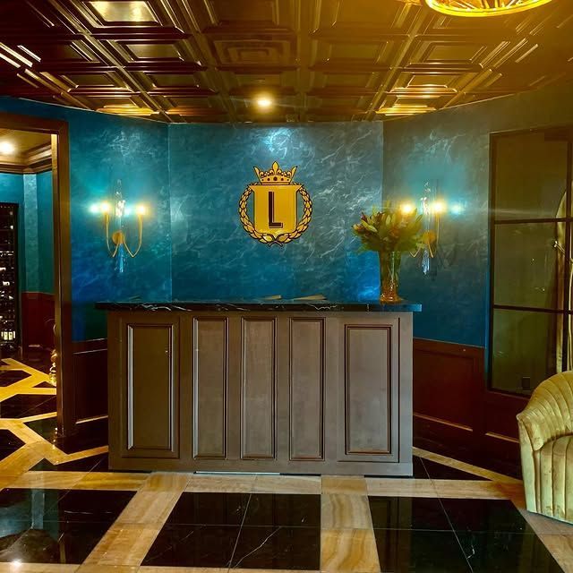 A hotel lobby with a large l on the wall