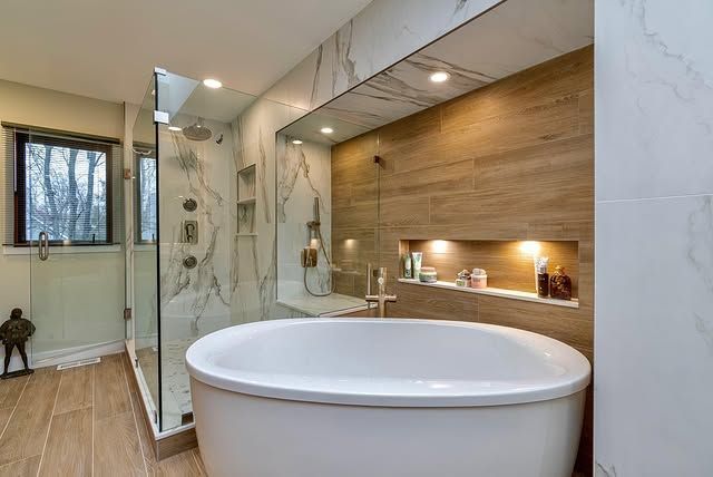 A bathroom with a bathtub and a walk in shower.