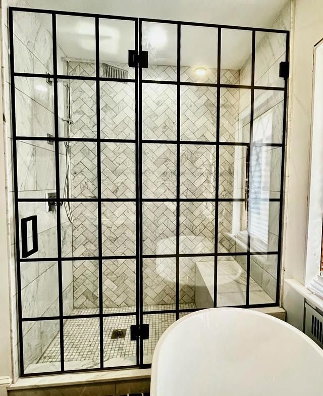 A bathroom with a walk in shower and a bathtub.
