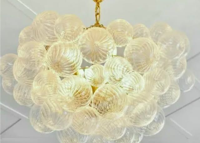 A chandelier made of clear glass balls is hanging from the ceiling.