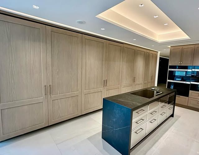 There is a large island in the middle of the kitchen.