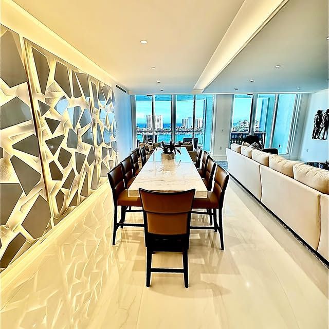A dining room with a long table and chairs