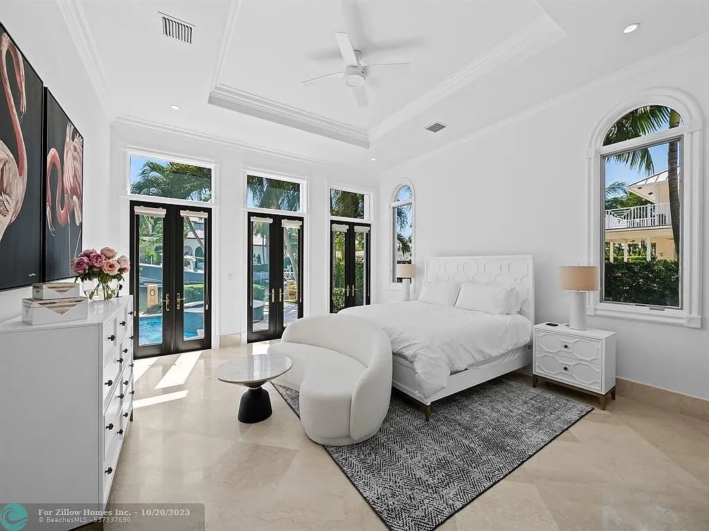 A bedroom with a large bed , a couch , a dresser , and a rug.