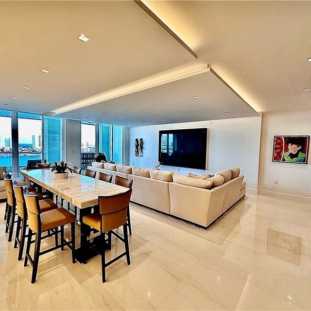 A living room with a couch a table and chairs